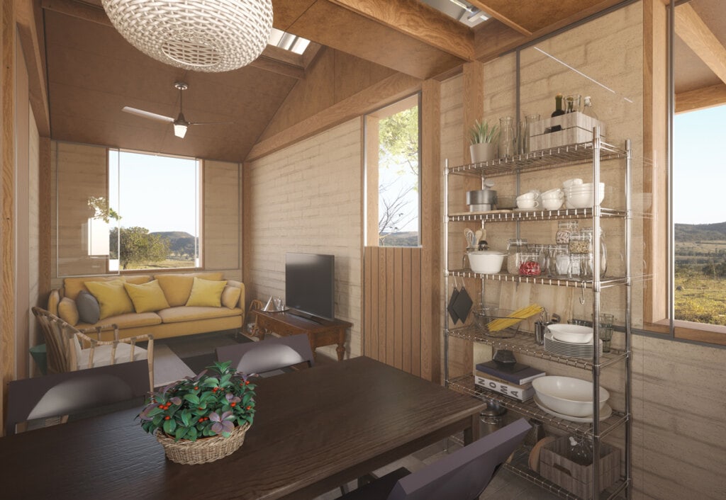 Vista interna da cozinha para a sala de estar, com seu pé direito característico e ambientes integrados entre si.